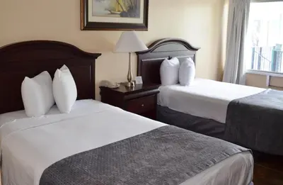 a hotel room with two beds and a window at Altamonte Springs Hotel and Suites in Orlando