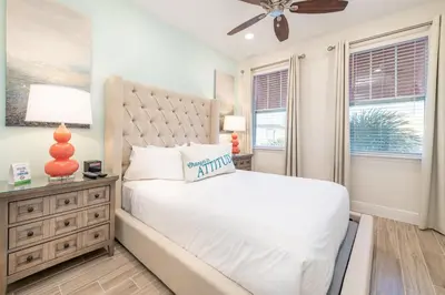 a bedroom with a white bed and a ceiling fan at Lake View Cottage With Private Pool Near Disney And Margaritaville Resort & Island H2O Access - 8089Su in Orlando