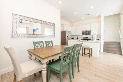 a kitchen and dining room with a wooden table and chairs at Lake View Cottage With Private Pool Near Disney And Margaritaville Resort & Island H2O Access - 8089Su in Orlando