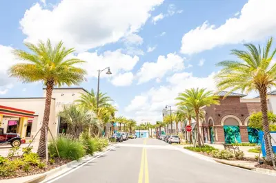 a street in a town with palm trees at Sandy Shores Cottage Near Disney With Margaritaville Resort & Island H2O Access - 8077Kd in Orlando