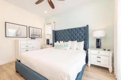 a bedroom with a large bed with a blue headboard at Ocean Blue Cottage Near Disney With Margaritaville Resort & Island H20 Waterpark Access - 2971La in Orlando