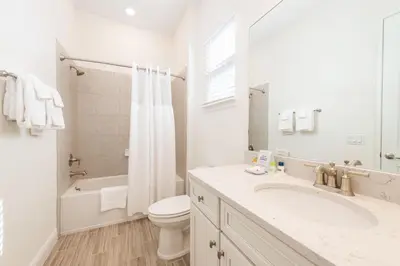 a white bathroom with a sink and a toilet at Ocean Blue Cottage Near Disney With Margaritaville Resort & Island H20 Waterpark Access - 2971La in Orlando