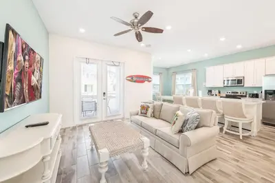 a living room with a couch and a ceiling fan at Seabreeze Cottage Near Disney With Margaritaville Resort & Island H2O Access - 8073Kd in Orlando