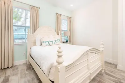 a white bedroom with a white bed and a window at Seabreeze Cottage Near Disney With Margaritaville Resort & Island H2O Access - 8073Kd in Orlando