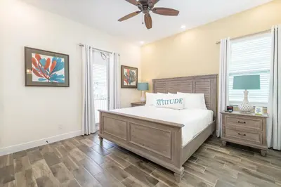 a bedroom with a bed and a ceiling fan at Coral Cottage Near Disney With Margaritaville Resort & Island H2O Access - 8063Kd in Orlando