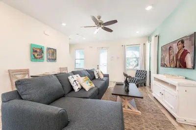 a living room with a couch and a ceiling fan at The Island Life! Near Disney With Margaritaville Resort & Island H2O Access - 8055Kd in Orlando