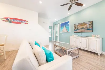 a living room with a white couch and a table at A Wave From It All Cottage With Private Pool Near Disney And Margaritaville Resort & Island H2O Access - 8039Su in Orlando