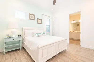 a white bedroom with a white bed and a table at A Wave From It All Cottage With Private Pool Near Disney And Margaritaville Resort & Island H2O Access - 8039Su in Orlando