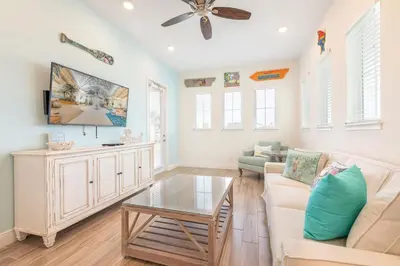 a living room with a couch and a table at A Wave From It All Cottage With Private Pool Near Disney And Margaritaville Resort & Island H2O Access - 8039Su in Orlando