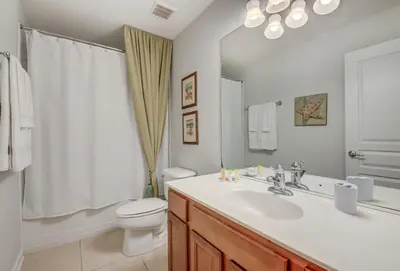 a bathroom with a white sink and a toilet at Spacious Home wPrivate PoolSpa & FREE Waterpark in Orlando