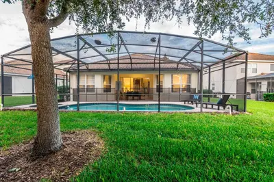 a house with a glass enclosure around a swimming pool at Spacious Home wPrivate PoolSpa & FREE Waterpark in Orlando