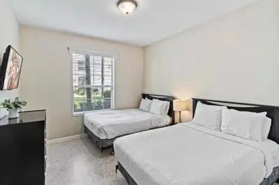 a bedroom with two beds and a window at First floor Vista Cay Condo wFREE Resort Access in Orlando