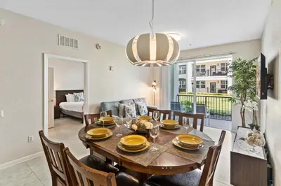 a dining room and living room with a table and chairs at First floor Vista Cay Condo wFREE Resort Access in Orlando