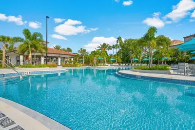 a swimming pool at a resort with palm trees at First floor Vista Cay Condo wFREE Resort Access in Orlando