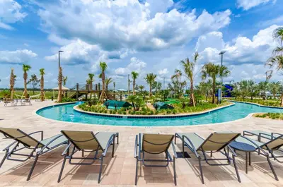 a pool at the resort with chairs and palm trees at 4814 Lullaby Lane in Kissimmee