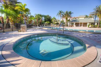 a small swimming pool in a park with palm trees at Beautiful Vista Cay Condo, Near I-Drive in Orlando
