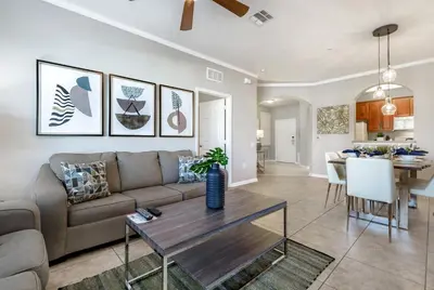 a living room with a couch and a table at Beautiful Vista Cay Condo, Near I-Drive in Orlando