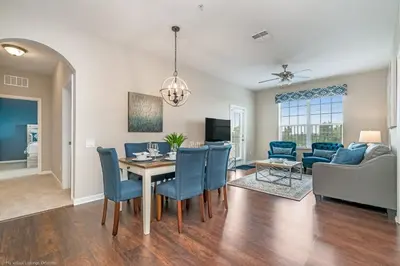 a dining room and living room with a table and chairs at Breakview Fun & Sun in Orlando
