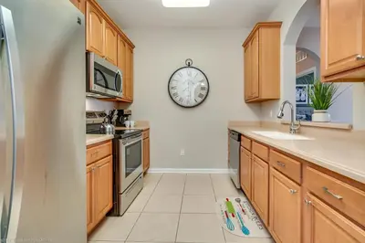 a kitchen with a clock on the wall at Breakview Fun & Sun in Orlando