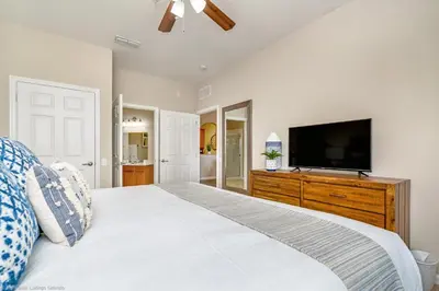 a bedroom with a large bed and a flat screen tv at Breakview Fun & Sun in Orlando