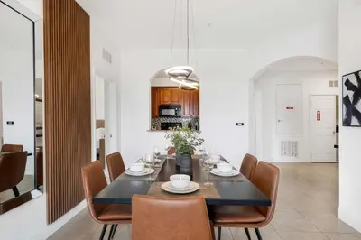 a dining room with a black table and chairs at Updated Condo Near Conv Ctr, I-Drive & Universal in Orlando