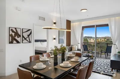 a dining room and living room with a table and chairs at Updated Condo Near Conv Ctr, I-Drive & Universal in Orlando