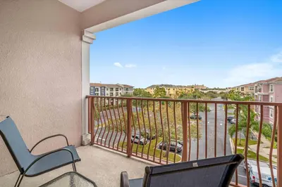 a balcony with chairs and a view of a street at Updated Condo Near Conv Ctr, I-Drive & Universal in Orlando