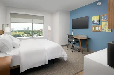 a hotel room with a white bed and a desk at Element Orlando Universal Blvd. in Orlando