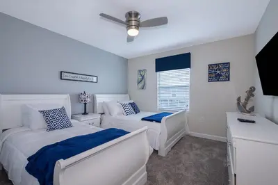 a bedroom with two beds and a ceiling fan at 4834BV TOWNHOUSE 4 BEDROOMS & 3 BATHROOMS + POOL in Kissimmee