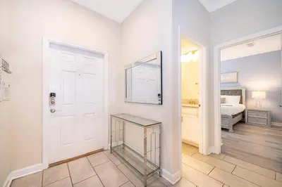 a room with a door and a glass table at 4833NF TOWNHOUSE 4 BEDROOMS & 3 BATHROOMS + POOL in Kissimmee