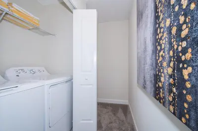 a laundry room with a washer and dryer at 4993FP TOWNHOUSE 4 BEDROOMS & 3 BATHROOMS + POOL in Kissimmee