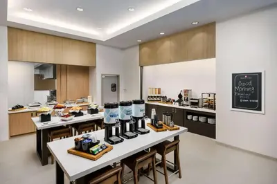 a kitchen with a table with food on it at Hilton Garden Inn Apopka City Center, Fl in Orlando
