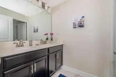 a bathroom with a sink and a mirror at 4929GC TOWNHOUSE 4 BEDROOMS & 3 BATHROOMS + POOL in Kissimmee