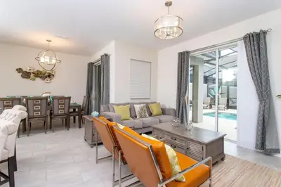 a living room with a couch and a table at Luxurious Décor 4 Bd w/ Pool Close to Disney 4820 in Kissimmee