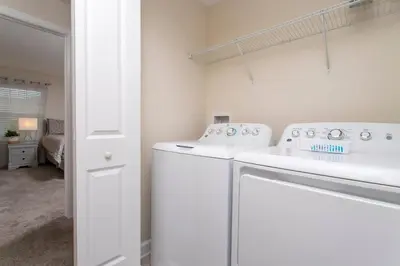 a white laundry room with a white washer at Luxurious Décor 4 Bd w/ Pool Close to Disney 4820 in Kissimmee