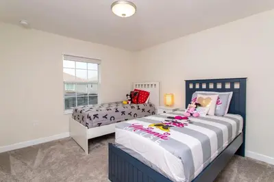 a bedroom with two beds and a window at Luxurious Décor 4 Bd w/ Pool Close to Disney 4820 in Kissimmee