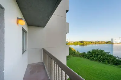 a balcony of a building with a view of a river at Deluxe Studio w/ Lakeview - free parking/pool in Orlando