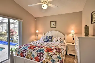 a bedroom with a bed and a ceiling fan at Family Home with Game Room 9 Mi to Disney World in Orlando