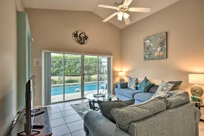 a living room with a couch and a tv at Family Home with Game Room 9 Mi to Disney World in Orlando