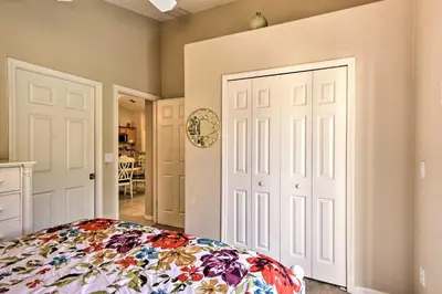 a bedroom with a bed with a floral bedspread at Family Home with Game Room 9 Mi to Disney World in Orlando