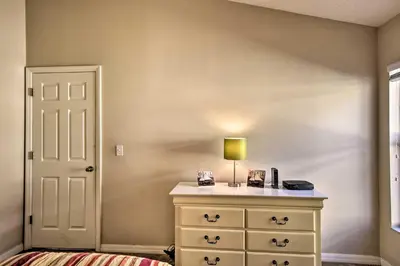 a bedroom with a dresser with a lamp on it at Family Home with Game Room 9 Mi to Disney World in Orlando