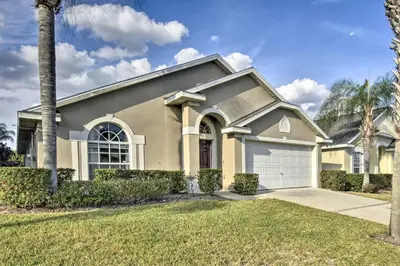 a house with a palm tree in front of it at Family Home with Game Room 9 Mi to Disney World in Orlando
