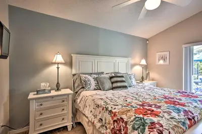a bedroom with a bed and a dresser with lamps at Family Home with Game Room 9 Mi to Disney World in Orlando