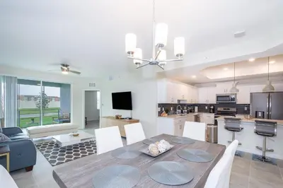 a dining room and kitchen with a table and chairs at 4721-101FG STOREY LAKE, CONDO 3/2 GARDEN VIEW in Kissimmee