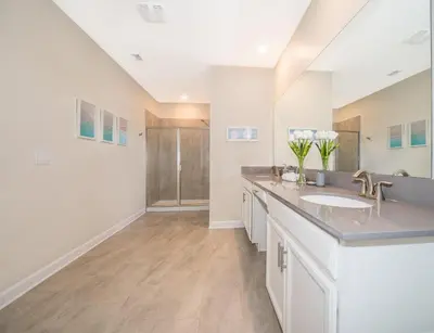 a bathroom with two sinks and a shower at 2770AG VILLA 5 BED/5 BA (SANITIZED) in Kissimmee