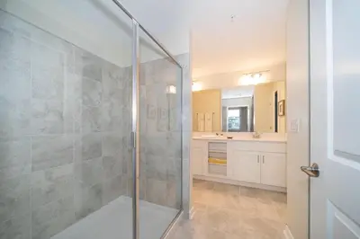 a bathroom with a shower with a glass door at 3120-201BB STOREY LAKE, CONDO 3/2 GARDEN VIEW in Kissimmee