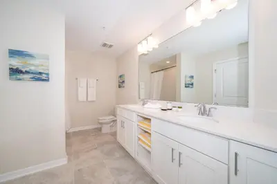 a white bathroom with a sink and a toilet at 3120-201BB STOREY LAKE, CONDO 3/2 GARDEN VIEW in Kissimmee