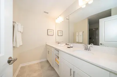 a bathroom with a sink and a large mirror at 3120-201BB STOREY LAKE, CONDO 3/2 GARDEN VIEW in Kissimmee
