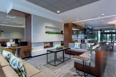 a lobby with a couch and a fireplace at Wyndham Garden Orlando Universal / I Drive in Orlando