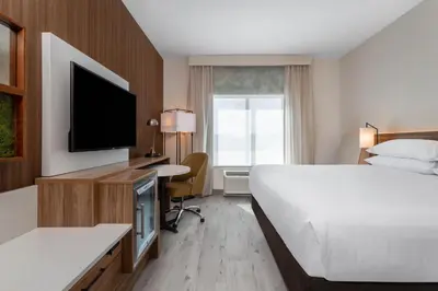 a hotel room with a bed and a flat screen tv at Wyndham Garden Orlando Universal / I Drive in Orlando
